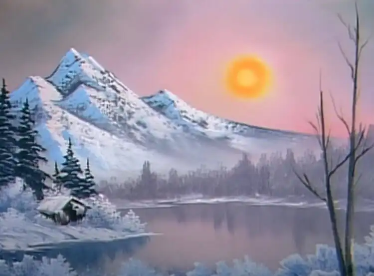 10 Bob Ross Paintings for Beginners 5 Bob Ross 'Winter Frost' painting featuring a snow-covered mountain with a warm sun.