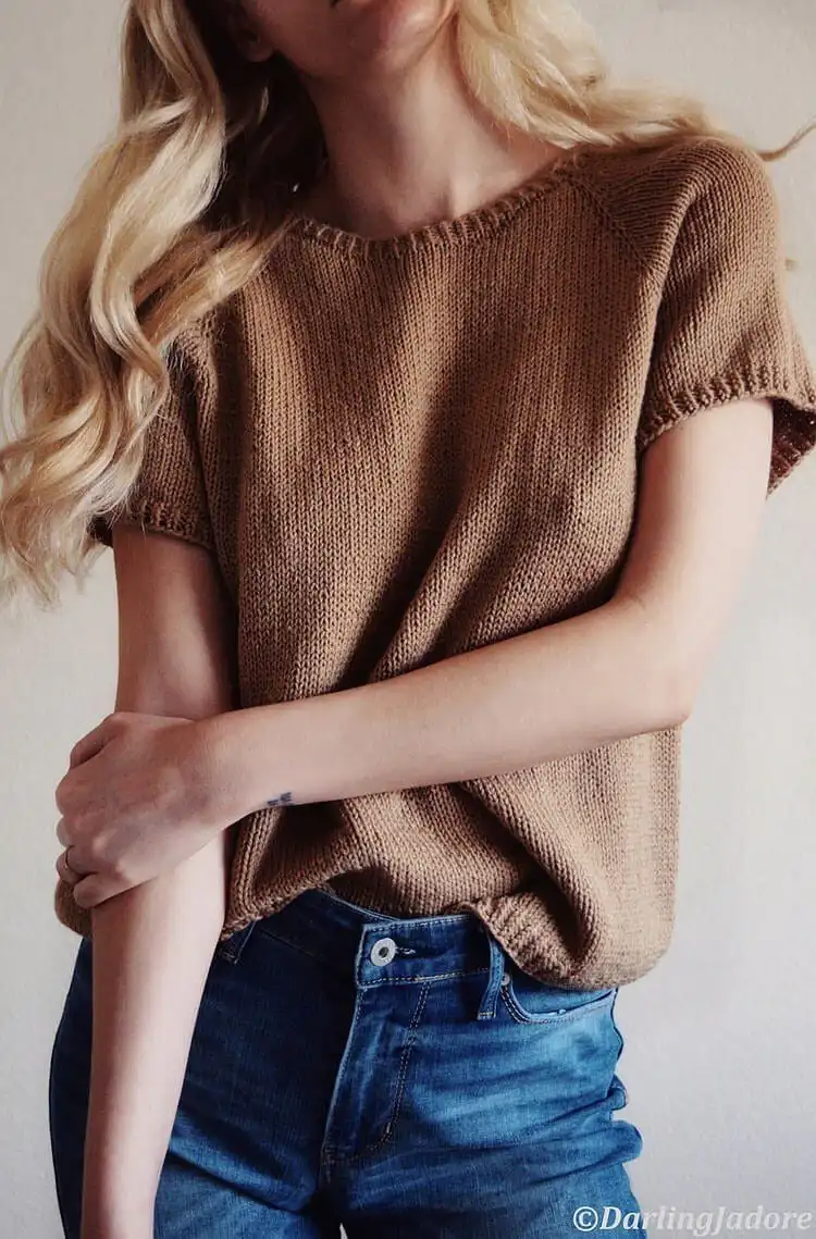 A classic knit tee with a slightly oversized, boxy fit in a solid color, demonstrating its timeless appeal and comfort.