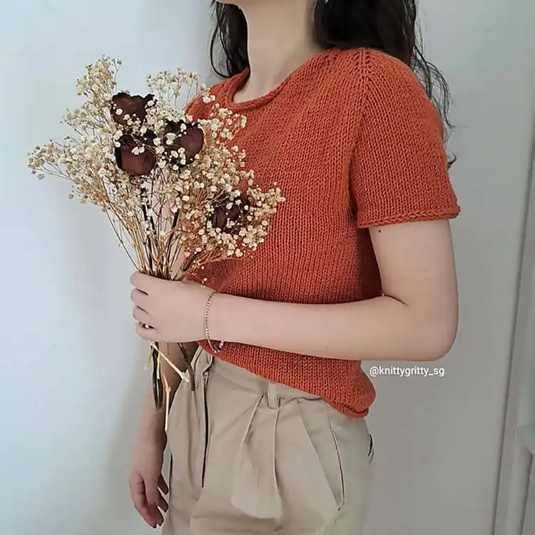 A knitted Picnic Folks Top featuring its unique pseudo-saddle shoulder construction and comfortable, stylish design.