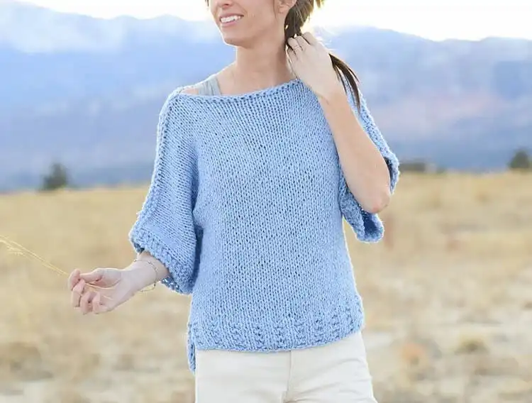 A model wearing a simple, comfortable Beginner Knit Sweater, showing its easy-to-wear style and basic knit stitches.