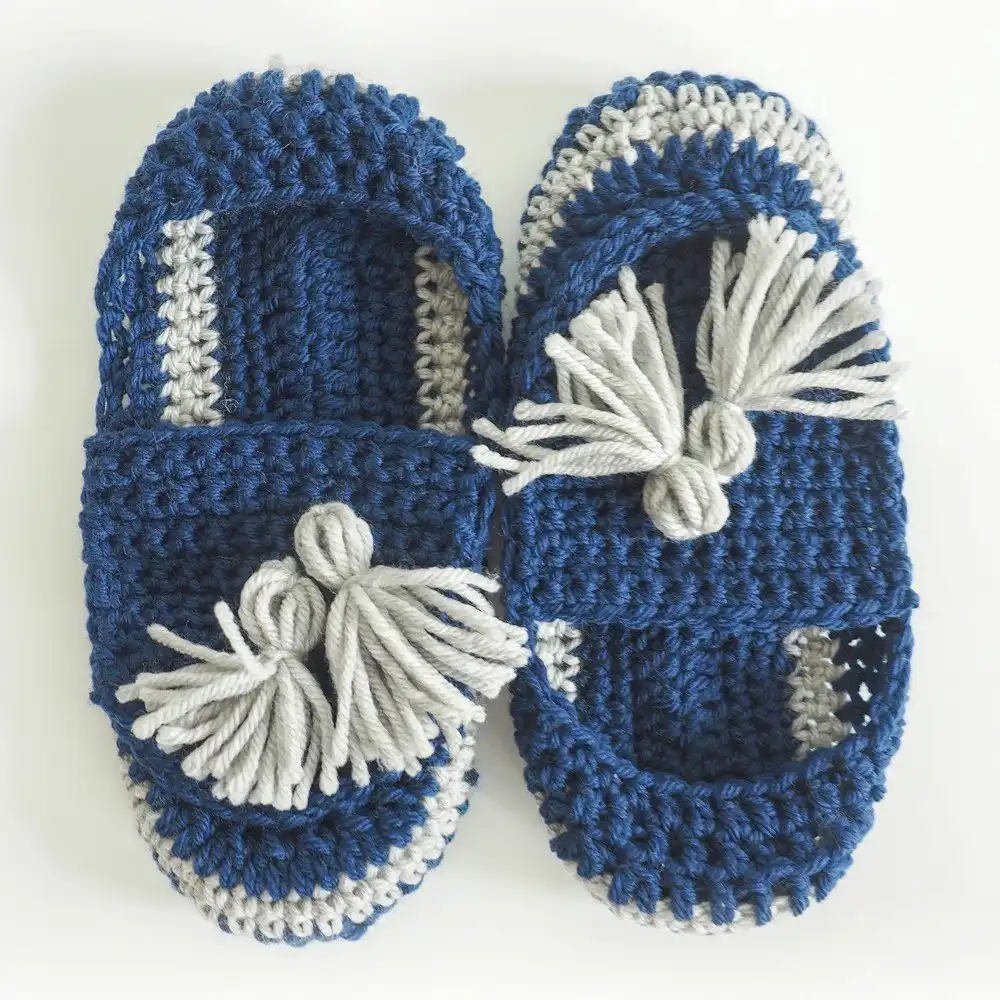 Boho-style crochet slippers with long fringe details and earthy tones.