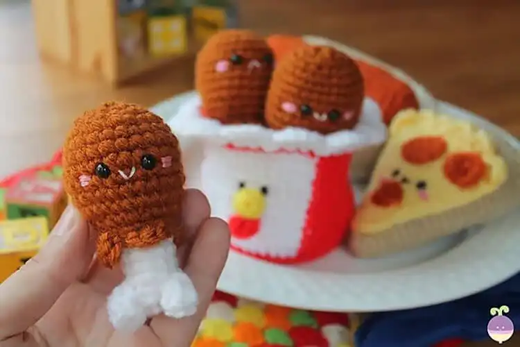 A whimsical Crochet Chicken Leg, resembling a fried drumstick, perfect for food-themed crafts.