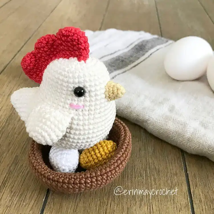 A lovingly crocheted Hen and Egg set, showing a proud chicken with her egg nestled in a handmade nest.
