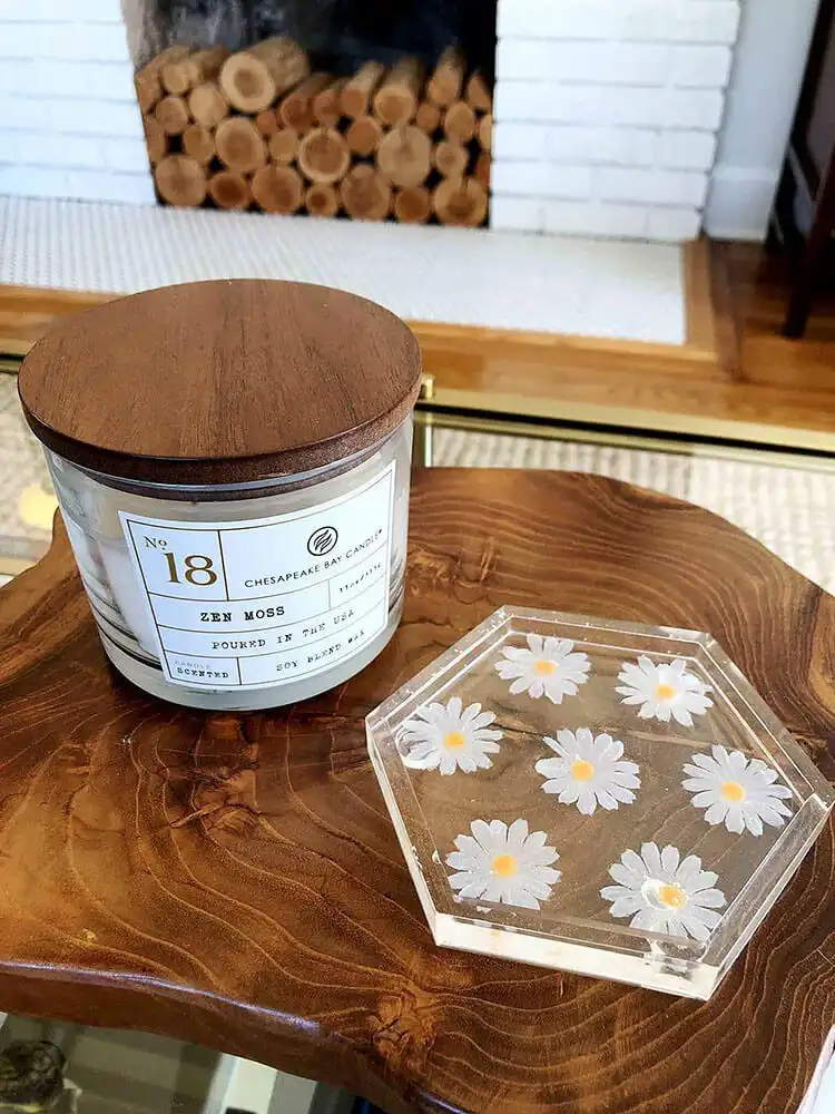 A set of handmade resin coasters with embedded dried flowers and glitter, showcasing clear and colorful designs.