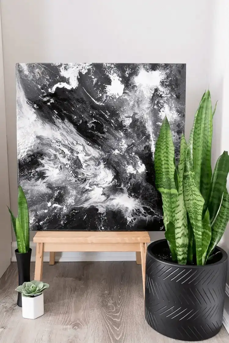 A mesmerizing galaxy-inspired epoxy resin paint pour art piece with deep blues, purples, and shimmering stars.