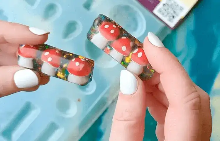 Delicate resin mushroom hair clips featuring tiny, realistic mushroom replicas embedded in clear resin.