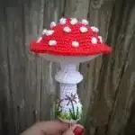 A group of Mushroom Amigurumi in various fall colors like red, brown, and pink, displayed together as decorative pieces.
