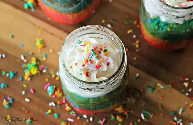 Mason Jar Rainbow Cake showcasing five vibrant layers of vanilla cake in a glass jar.