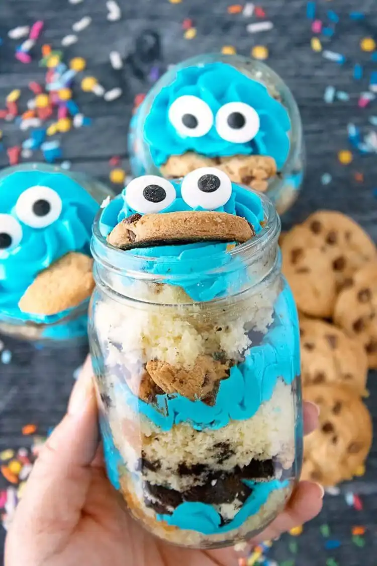 Cookie Monster Cake Jars filled with vanilla cake, chocolate chip cookies, and Oreo cookie crumbles.