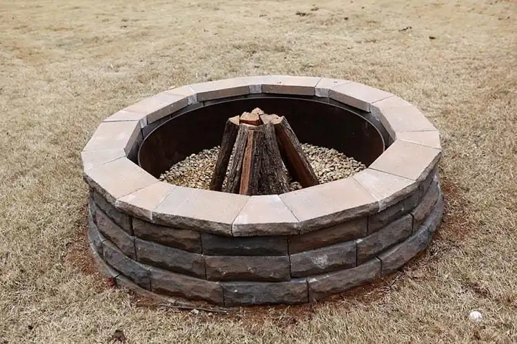Neat Easy Fire Pit DIY constructed from uniform brown concrete blocks, featuring a clean edge and suitable for any basic backyard setup.