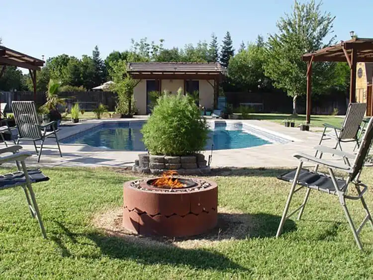 Creative $50 Fire Pit Using Concrete Tree Rings, showcasing a clever design using stacked concrete tree rings for a cheap yet effective fire pit.