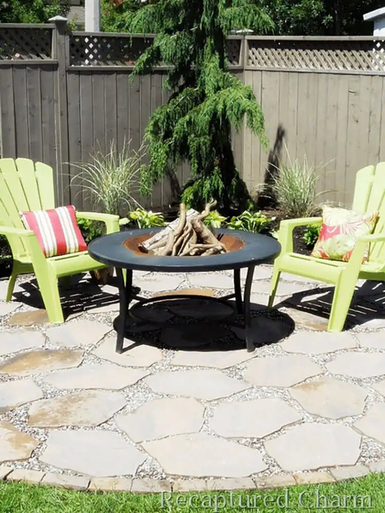 Inviting Fire Pit Patio featuring a round stone fire pit as the focal point, surrounded by comfortable Adirondack chairs and string lights, ideal for evening gatherings.