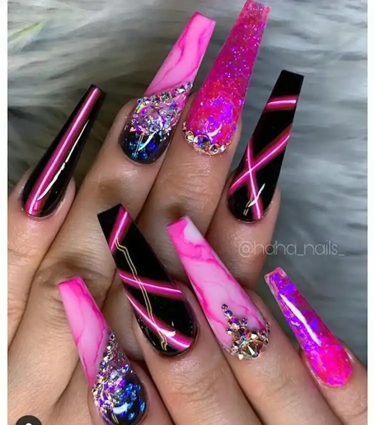 Dramatic long pink and black nails adorned with rhinestones and glitter, featured in 16 Extraordinary Pink And Black Nail Design Ideas - French Tip Square Acrylic Nails