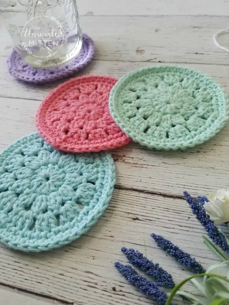 Spring-colored crochet coasters with a delicate floral or lacy pattern