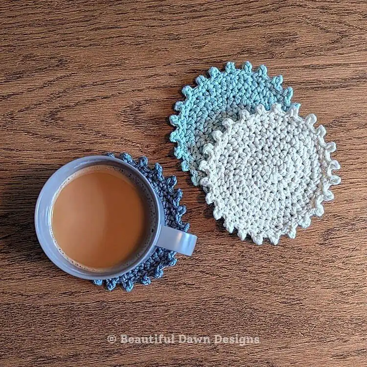 Textured blue crochet coaster with a delicate edge, 'Blue Skies Coaster'