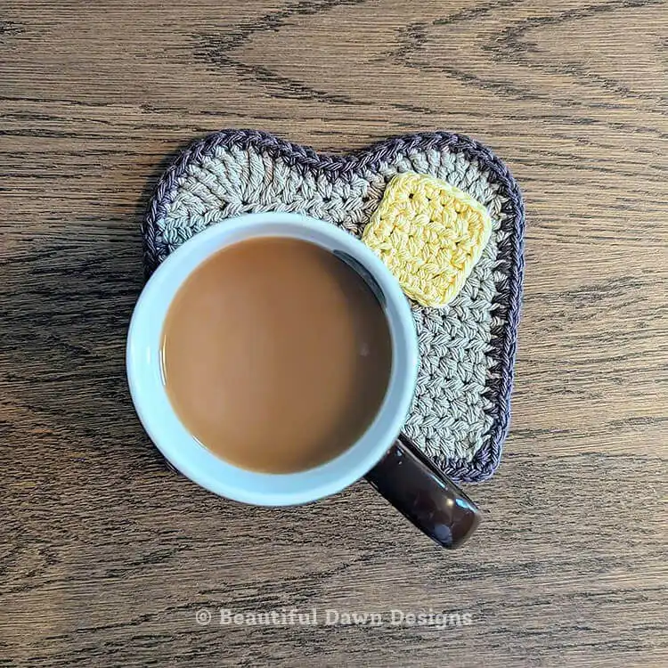 Humorous crochet buttered toast coaster with a pat of yellow butter
