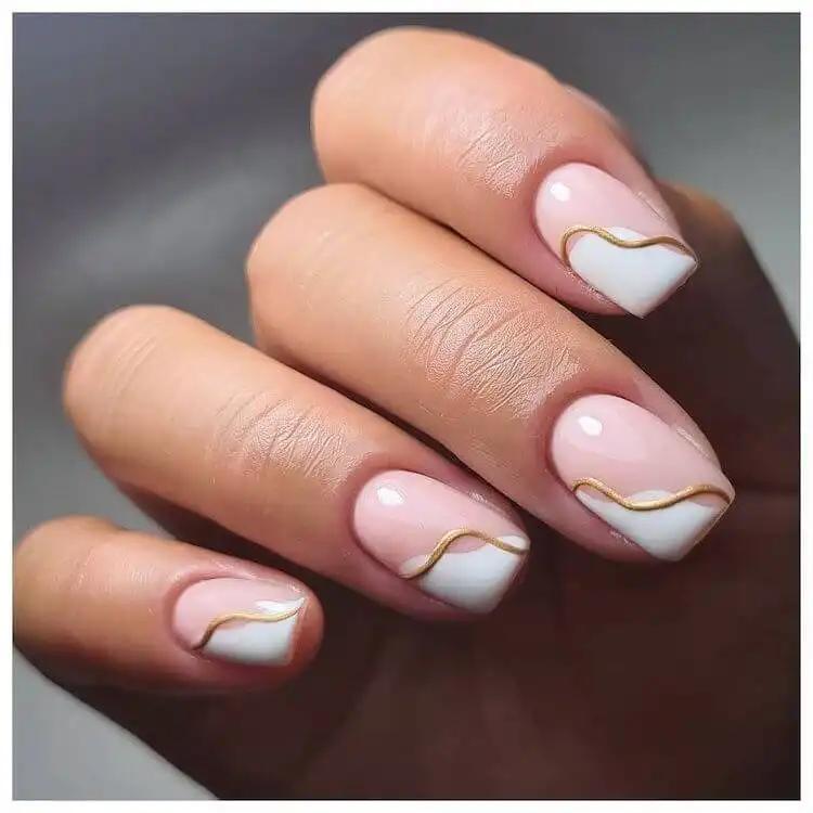 Elegant short acrylic nails showcasing 16 white and gold designs perfect for any occasion.