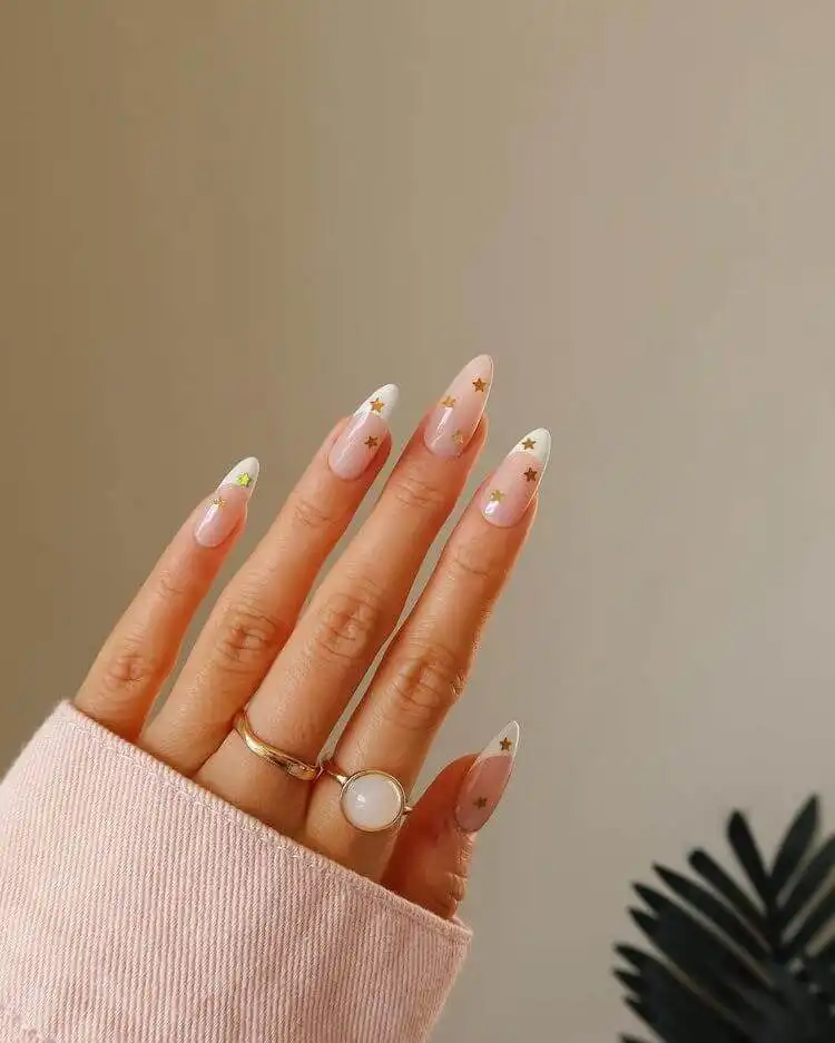 Simple yet beautiful white nails with delicate gold swirls, perfect for everyday elegance.