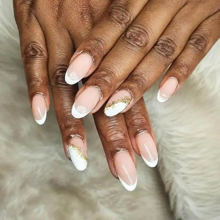 Elegant French tip nails on short acrylics with subtle gold foil accents.