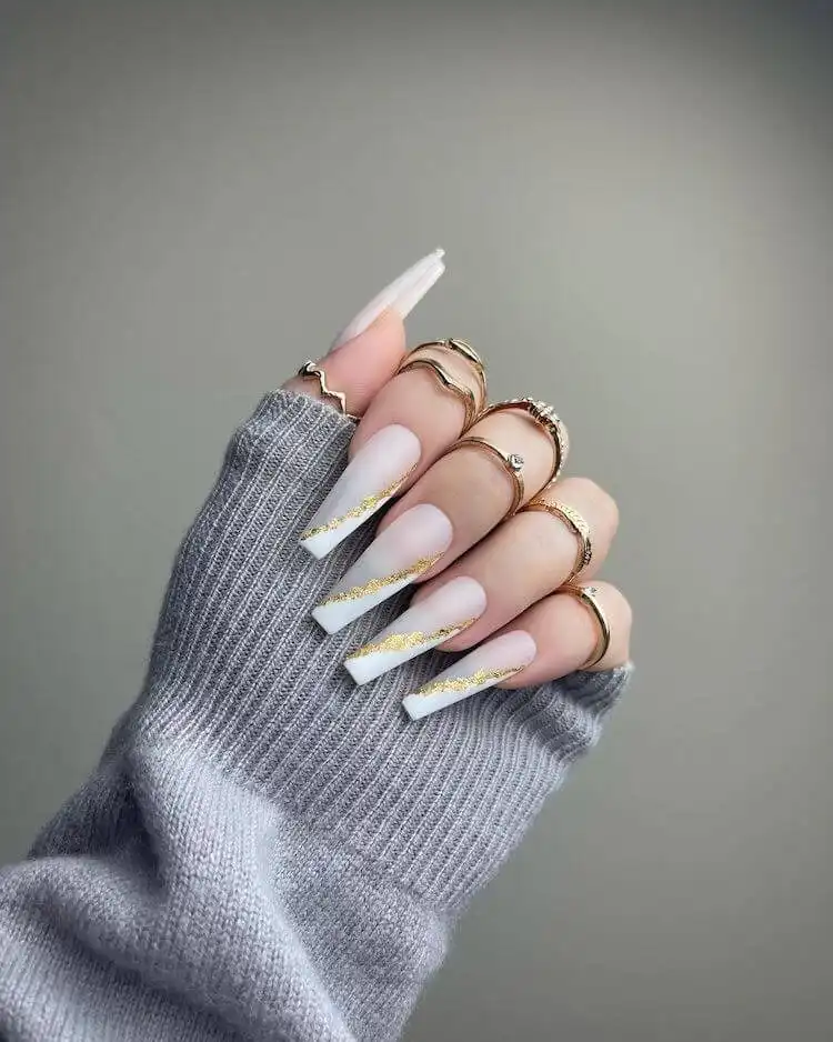 White and gold press-on nails with stunning gold foil accents.