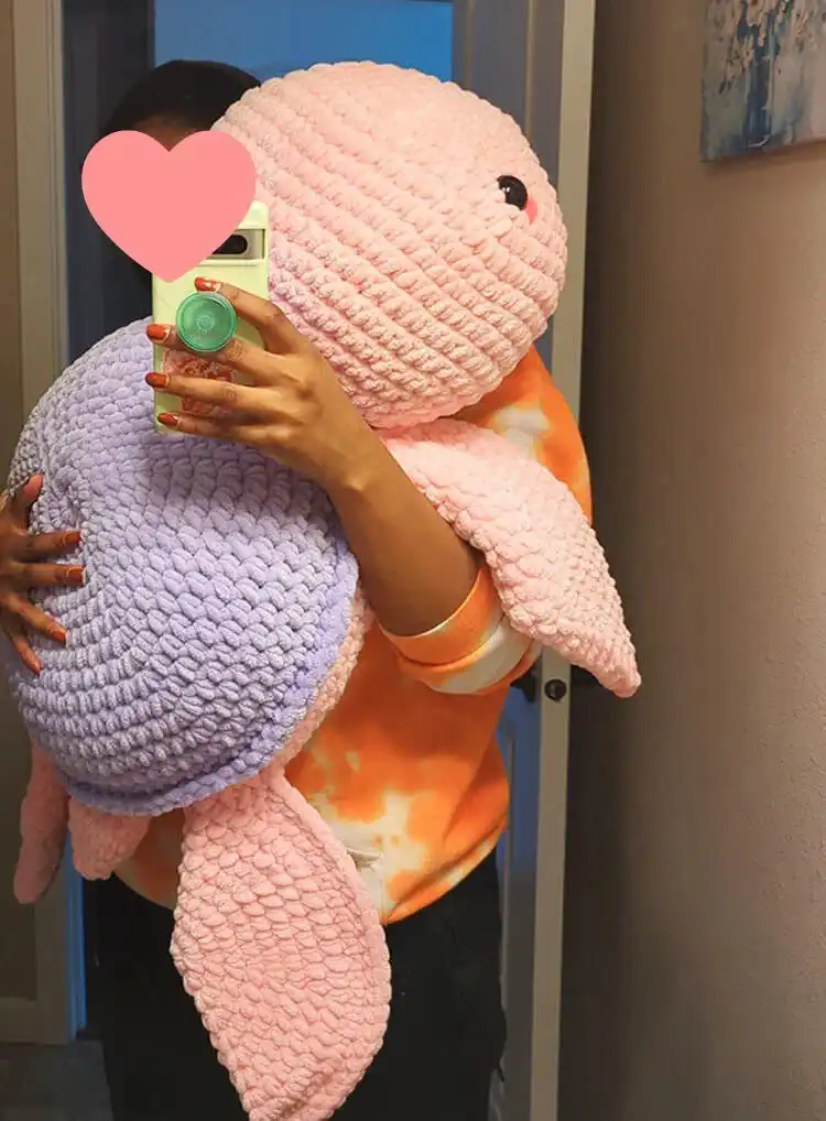 A large, green jumbo crochet turtle, approximately 26 inches wide, with a textured shell and friendly eyes.