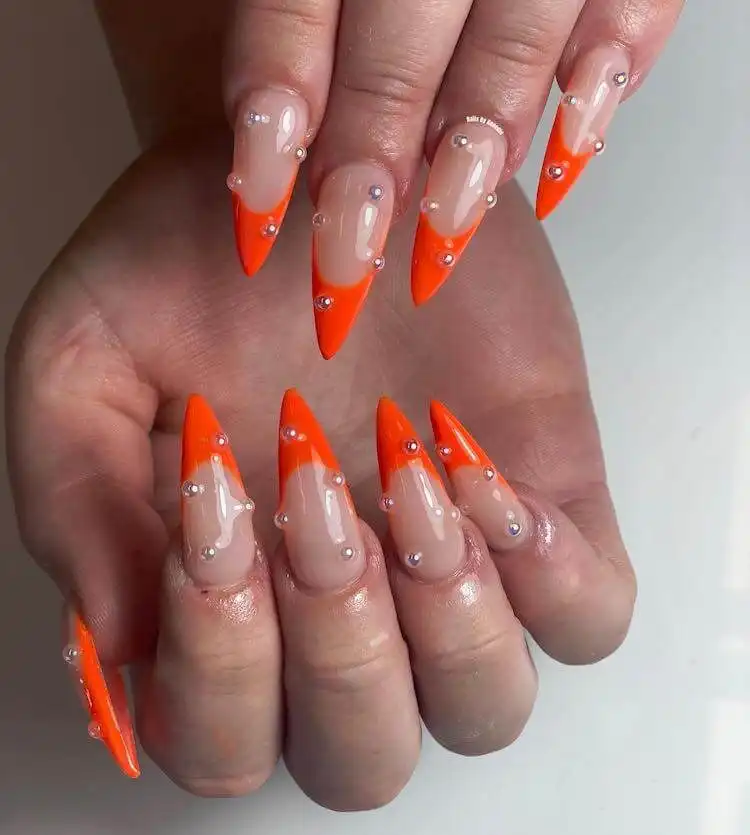 18 Simple Orange Nail Designs - Heart Nails 14 Stiletto nails decorated with delicate pearls and vibrant orange tips, creating a luxurious design.