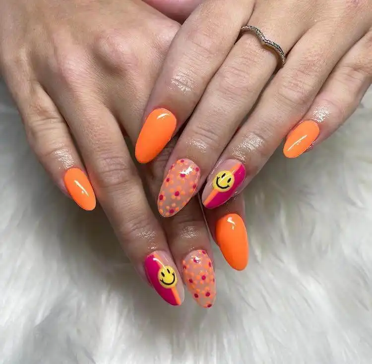 18 Simple Orange Nail Designs - Heart Nails 16 Playful nail art with bright flowers and cheerful smiley faces on an orange background.