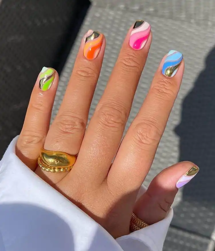 18 Simple Orange Nail Designs - Heart Nails 2 Manicure featuring fluid, colorful wavy lines in various shades of orange, a creative example from 18 Simple Orange Nail Designs.