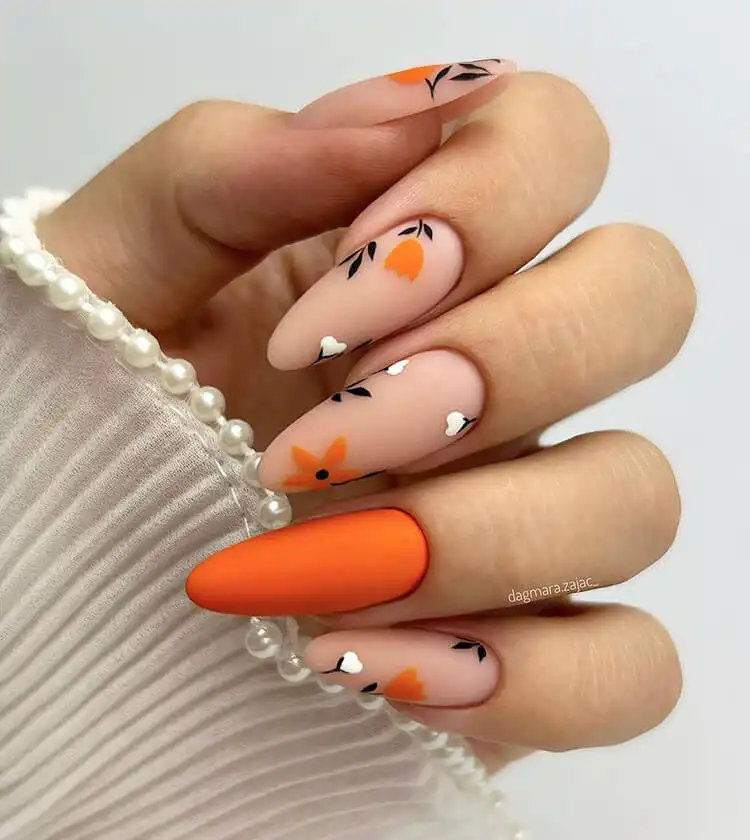 18 Simple Orange Nail Designs - Heart Nails 23 Elegant floral design on nails featuring delicate orange and white flowers.