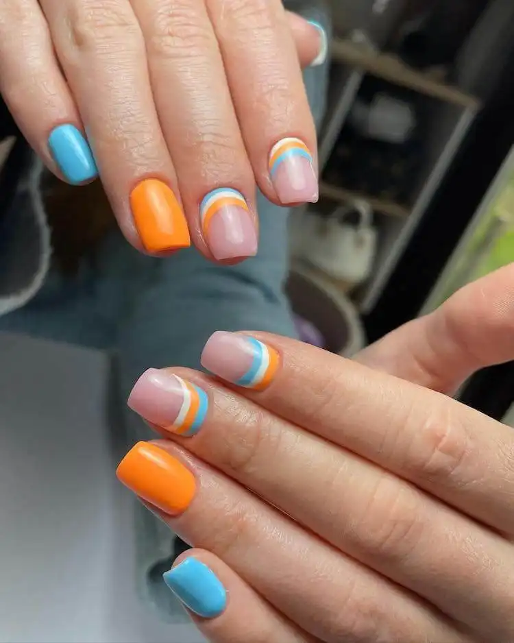 18 Simple Orange Nail Designs - Heart Nails 8 Retro-inspired nail art with bright orange and blue colors in a funky, abstract design.