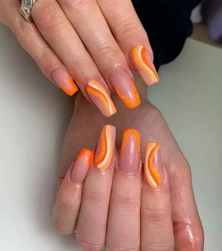18 Simple Orange Nail Designs - Heart Nails 9 Sparkling orange glitter nails, adding a festive and glamorous touch to a manicure.