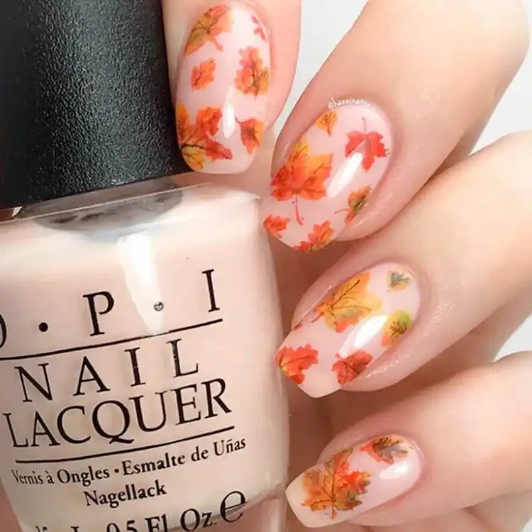 Classic short coffin nails featuring understated tan French tips against a sheer or nude base, exuding timeless elegance.