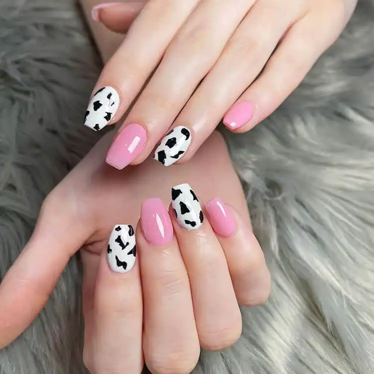 Festive short coffin nails adorned with a playful confetti-themed design, featuring a scattering of colorful dots on a light base.