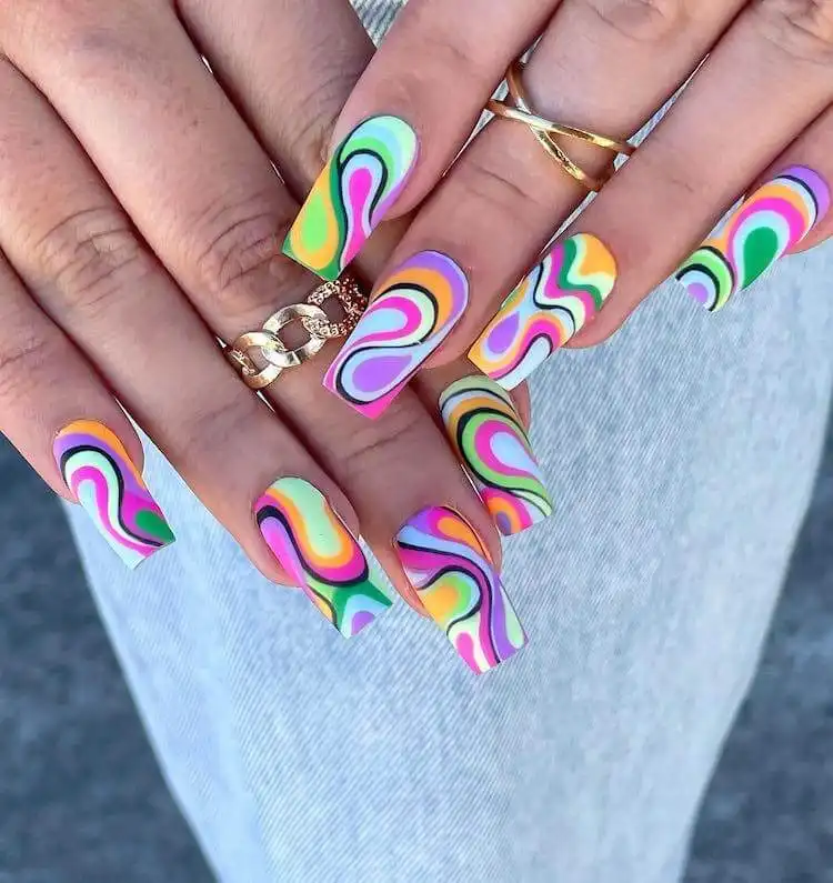 Tapered square nails featuring abstract, artistic patterns on the tips.