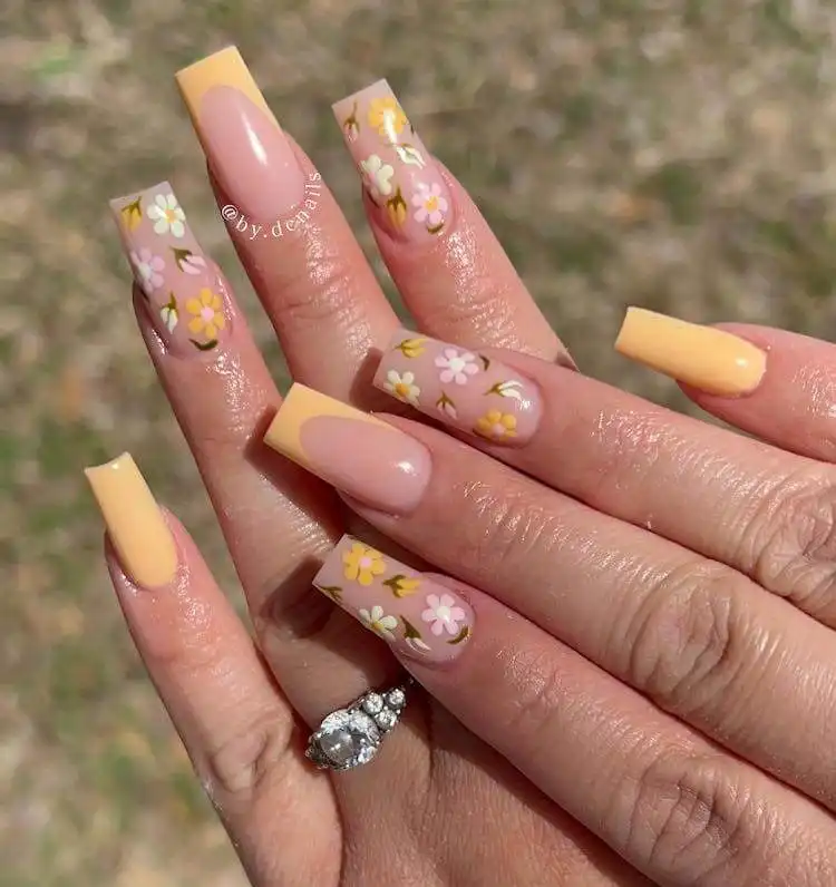 Elegant tapered square nails featuring hand-painted yellow flowers on a soft pink base.