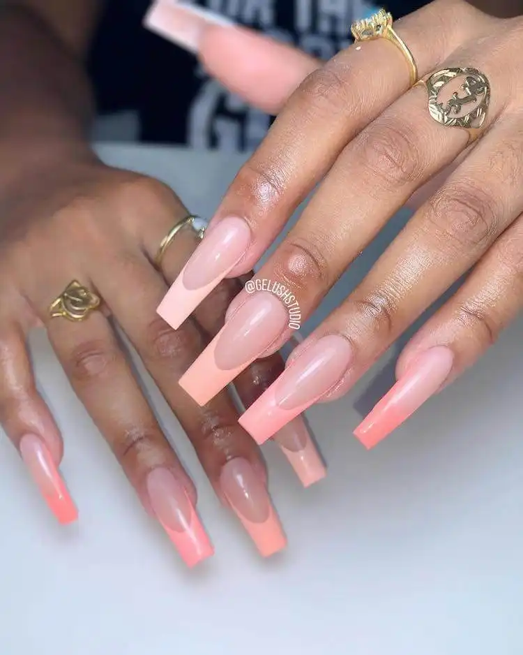 Blush-colored ombre French tips on tapered square nails for a modern twist.