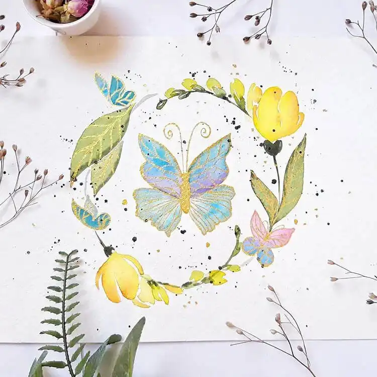 Elegant watercolor butterfly with metallic gold lines highlighting its wing design.