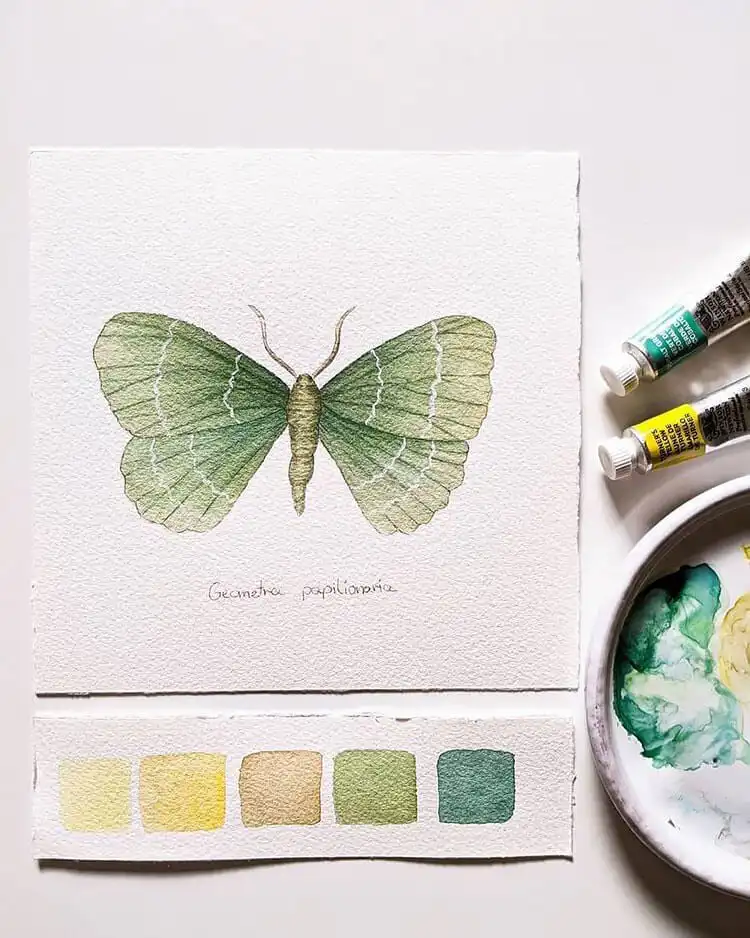 Watercolor painting of an iridescent emerald butterfly with vibrant green and blue hues.