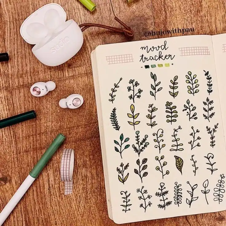 Cute paper planes mood tracker in a bullet journal, each plane colored for a daily emotional record.