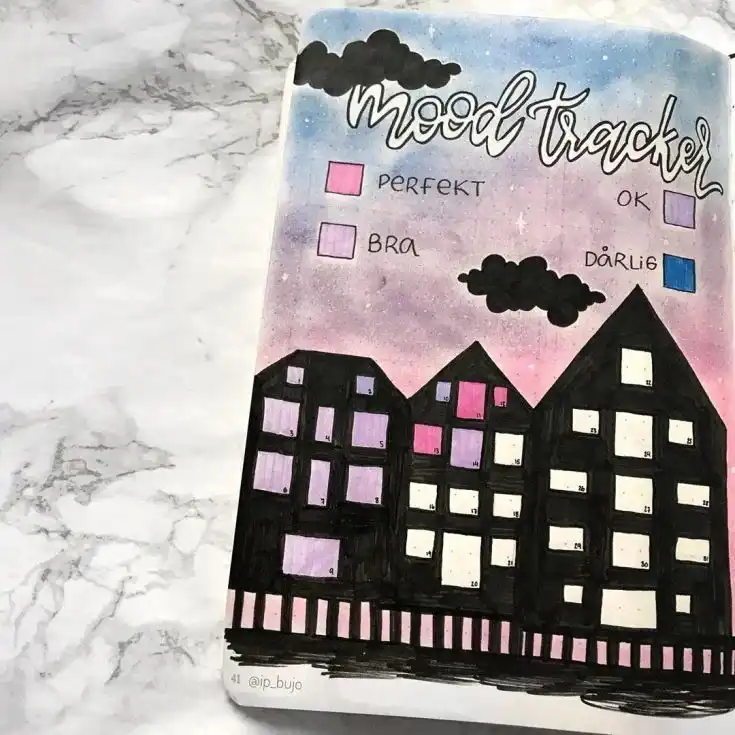Simple and elegant sakura tree mood tracker in a bullet journal, with falling petals colored for daily moods.