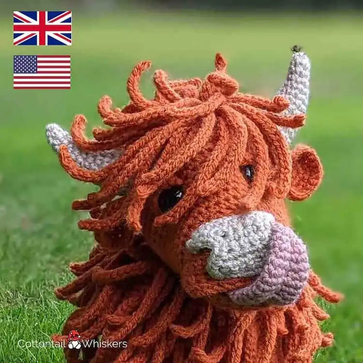 A crochet Highland Cow plushie with distinctive shaggy brown hair and small horns, capturing its unique character.