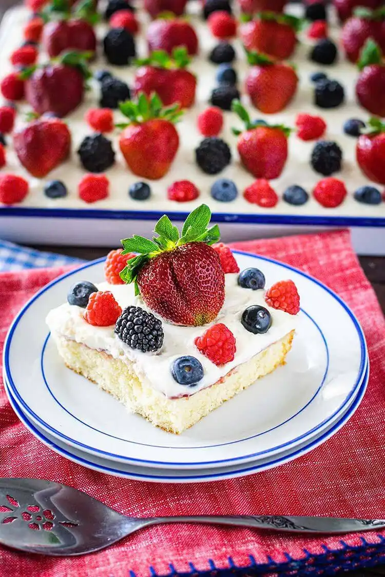 Elegant Chantilly sheet cake topped with fresh berries and cream