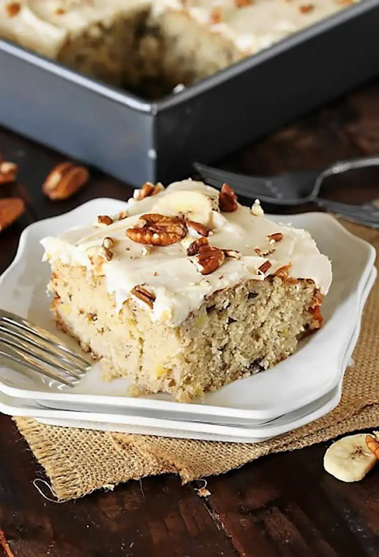 Slice of hummingbird sheet cake with cream cheese frosting