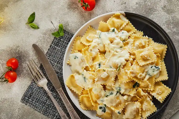 Homemade agnolotti pasta filled with squirrel, served in a light sauce, an elegant pasta dish