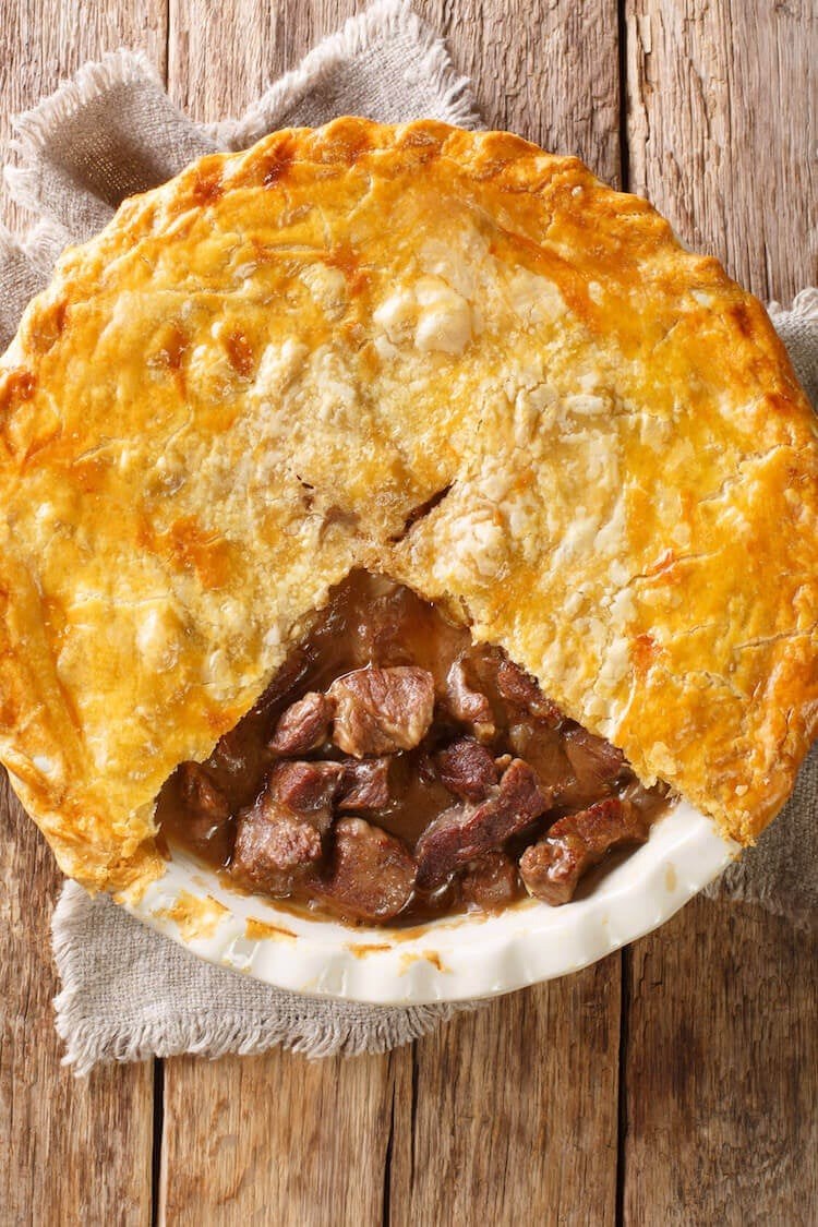 Squirrel pot pie in a ramekin with a puffed pastry top, a classic comfort food