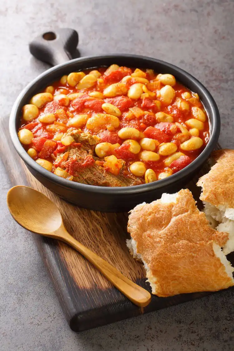 Old-fashioned squirrel stew in a Dutch oven, slow-cooked to perfection, a traditional dish