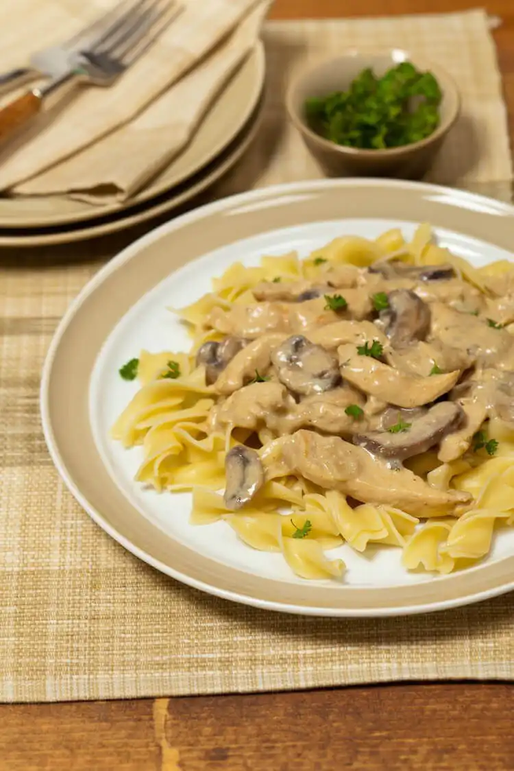Squirrel and mushrooms in a creamy sauce, garnished with herbs, an elegant squirrel recipe