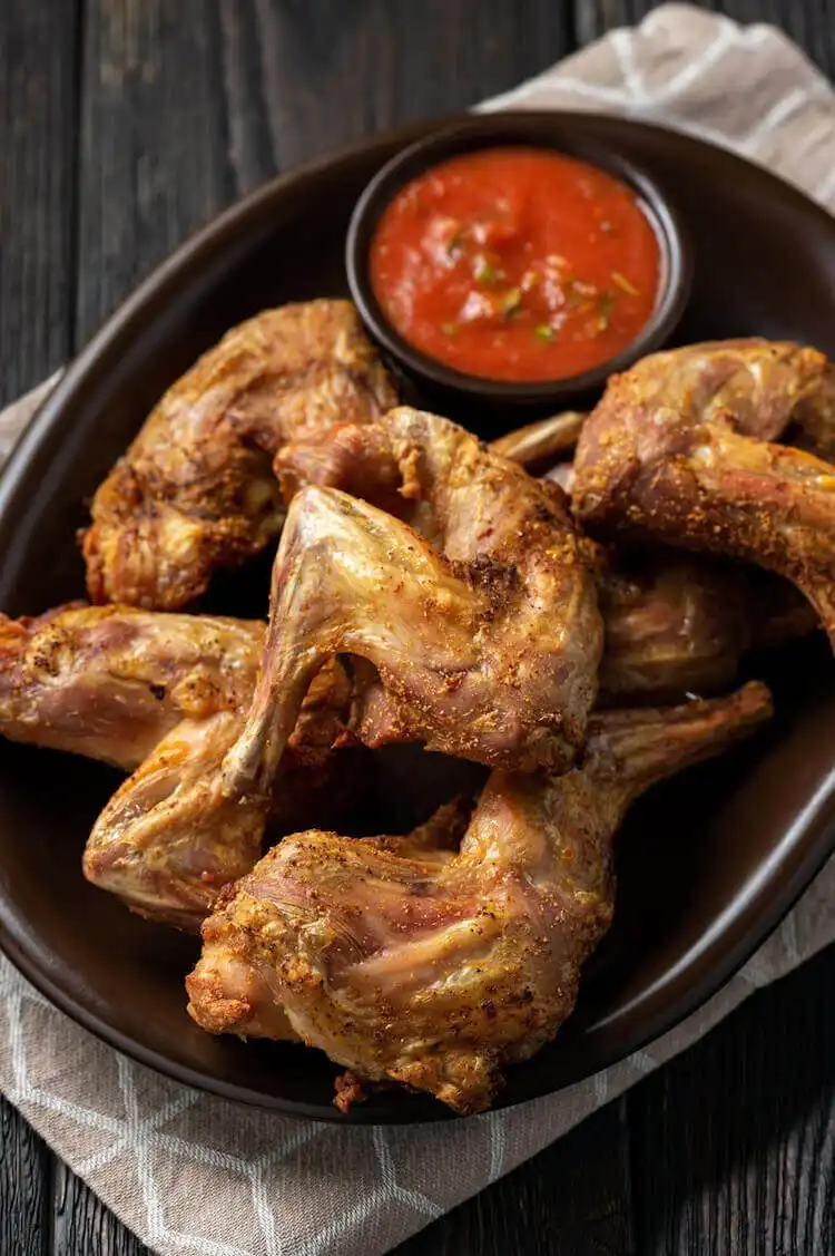 Crispy fried squirrel pieces on a plate, golden brown and seasoned, a Southern comfort food