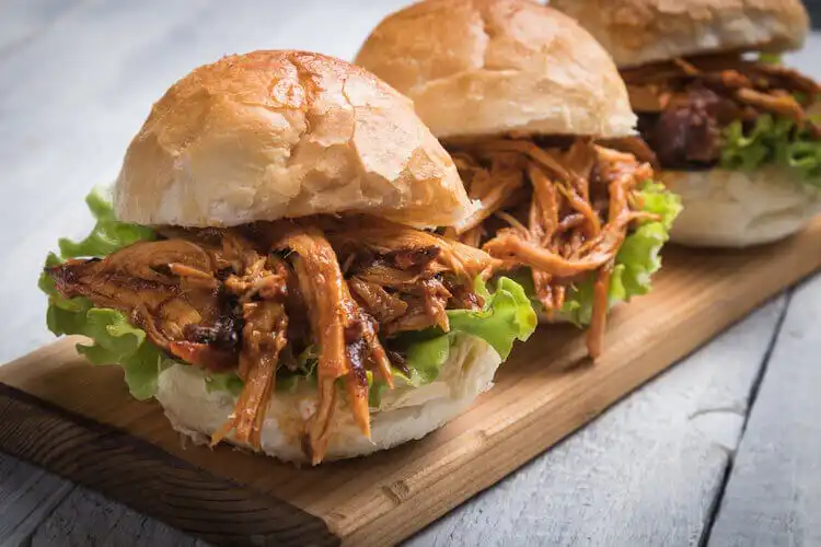 Barbecued smoked squirrel sandwich with coleslaw, piled high on a bun, a unique game sandwich