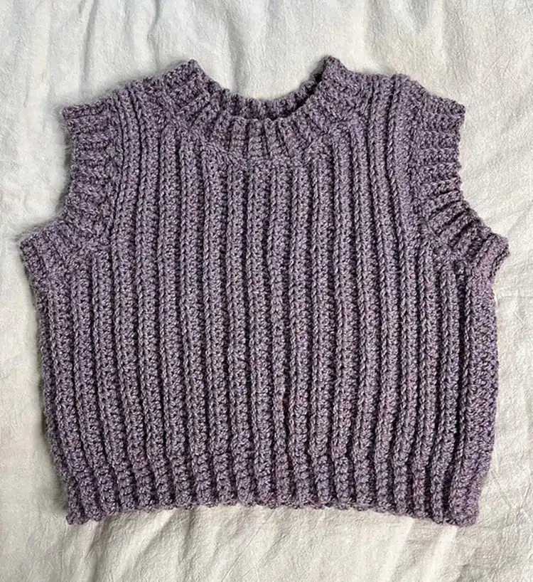A classic Ribbed Sweater Vest in a neutral color, showcasing the defined vertical ribbing and crewneck design.